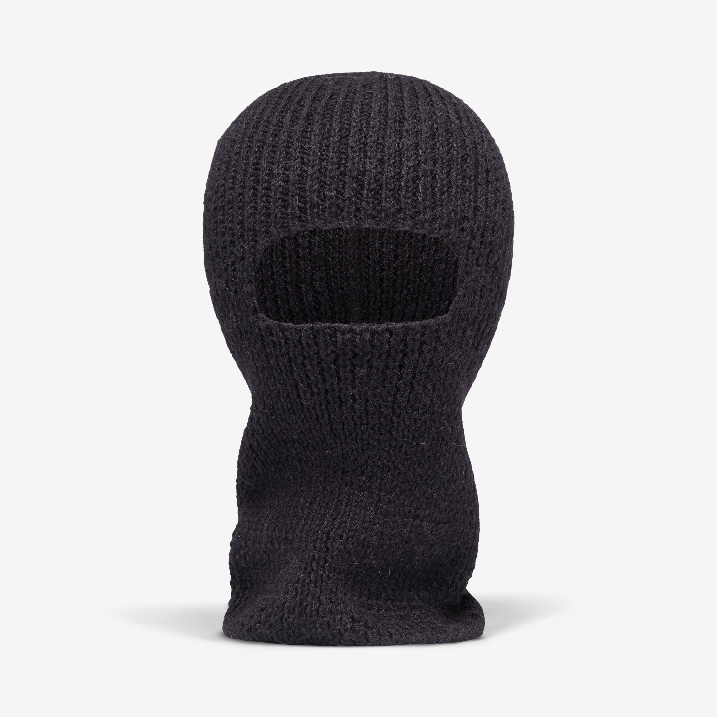 A black hand-knitted alpaca wool balaclava with a rectangular opening for the eyes.