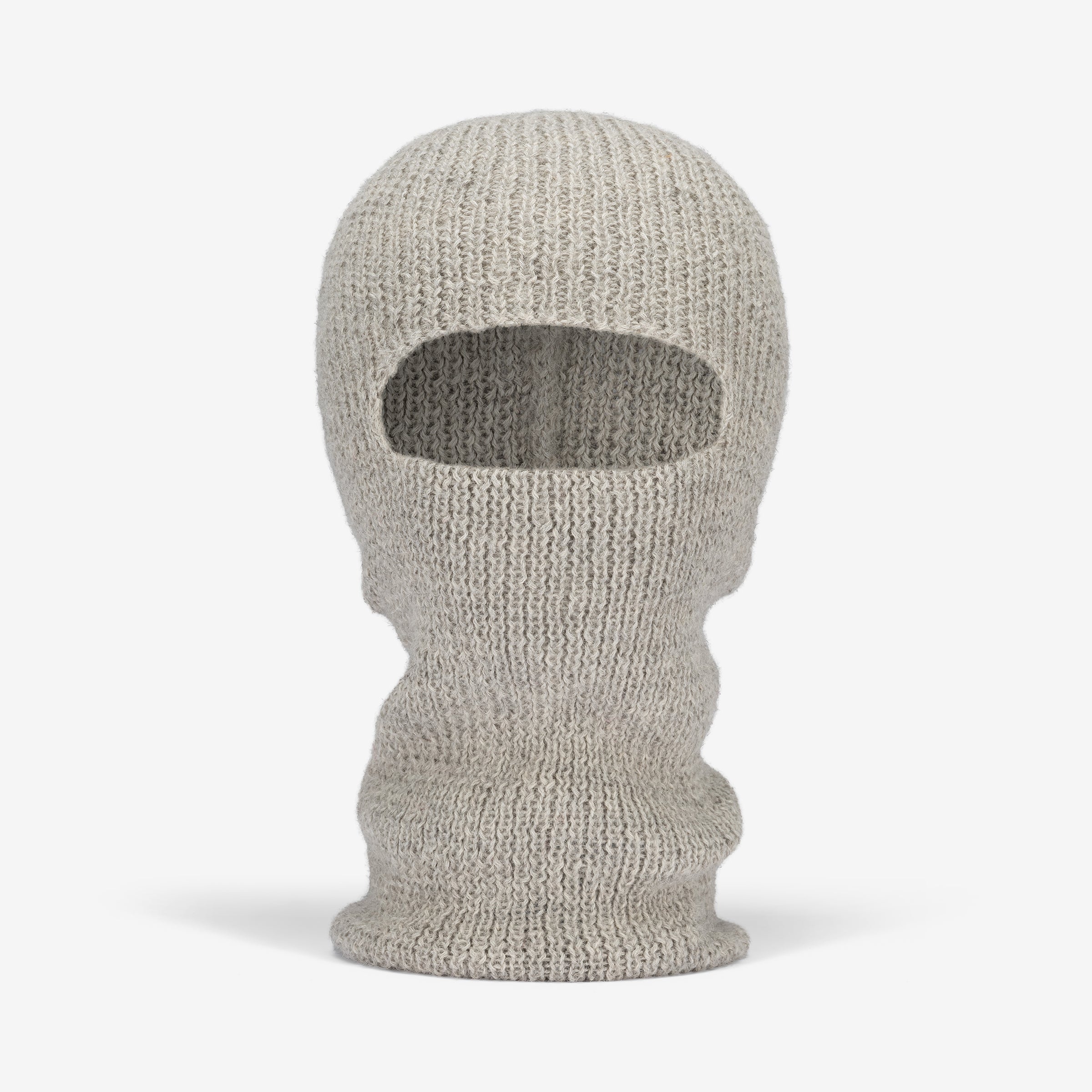 A hand-knit alpaca balaclava in gray, featuring a hole for the eyes and mouth, designed to cover the entire head and neck.