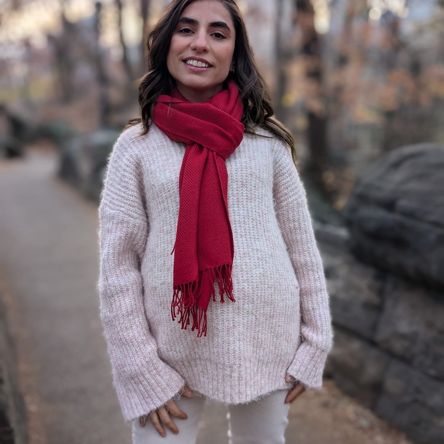 Woman wearing a red scarf and light sweater in Central Park