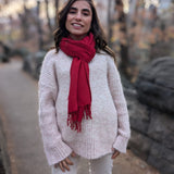 Woman wearing a red scarf and light sweater in Central Park