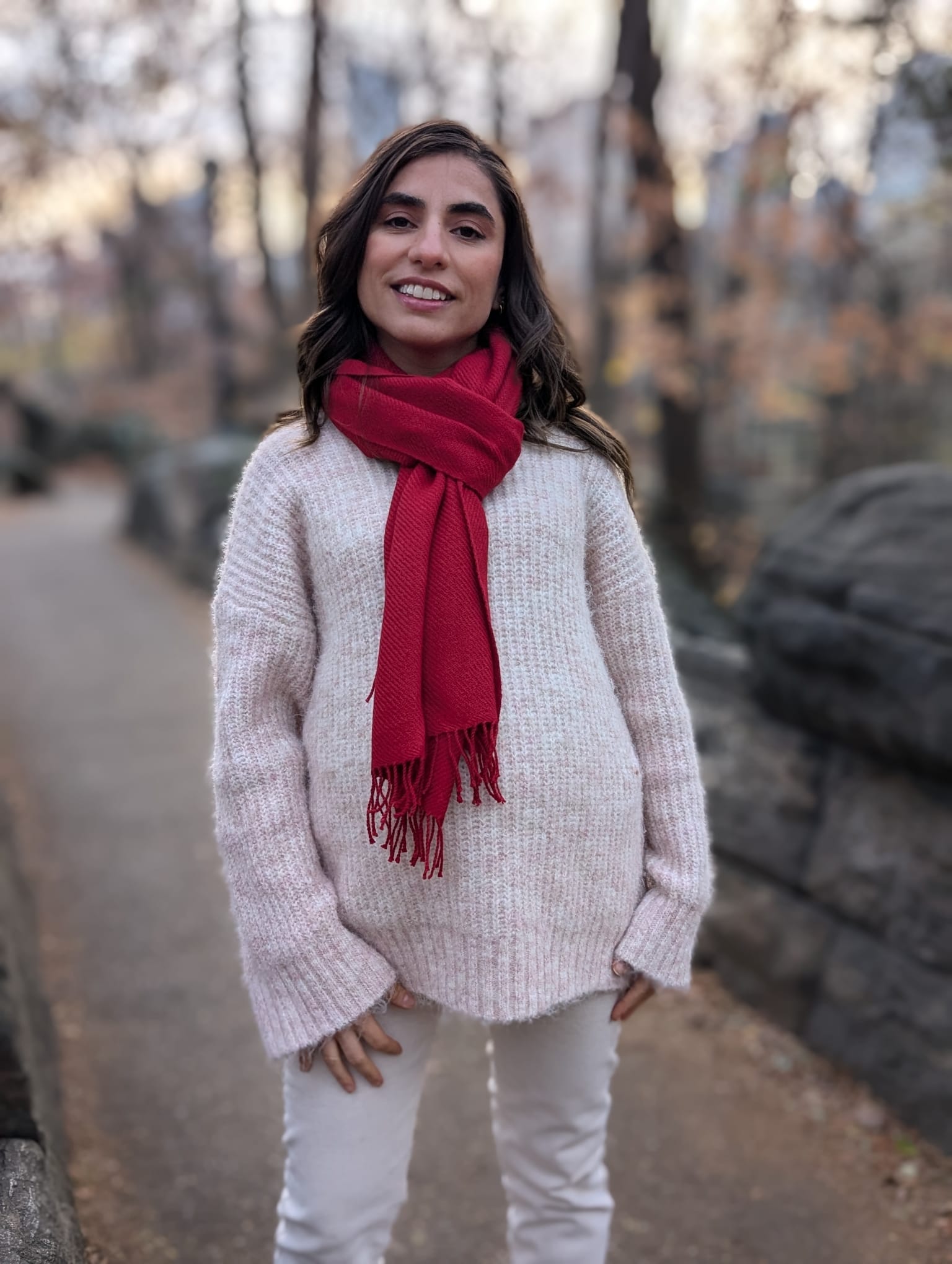 Woman wearing a red scarf and light sweater in Central Park