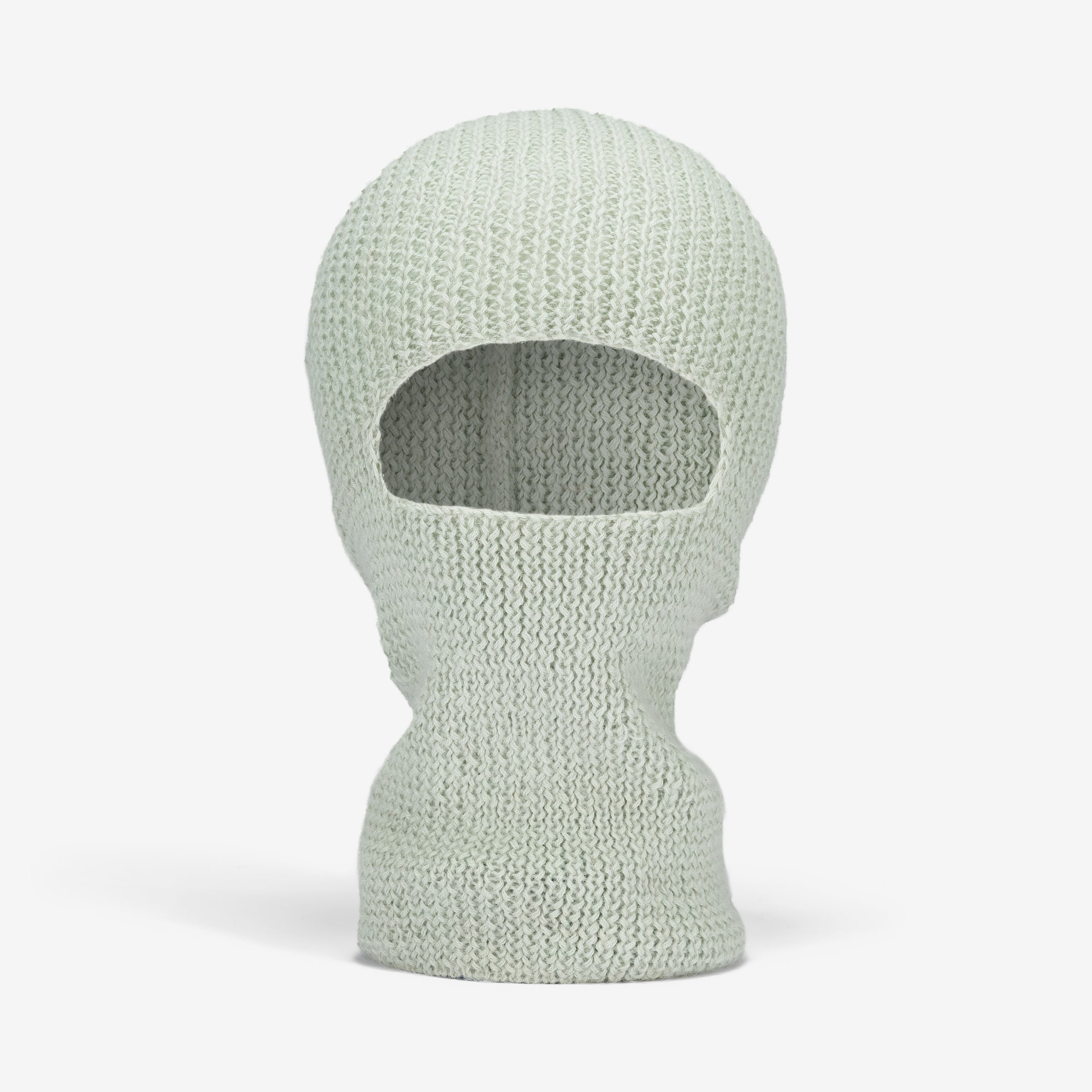 A hand-knit alpaca balaclava in Mint color, showing a front view with a hole for the eyes and mouth visible.
