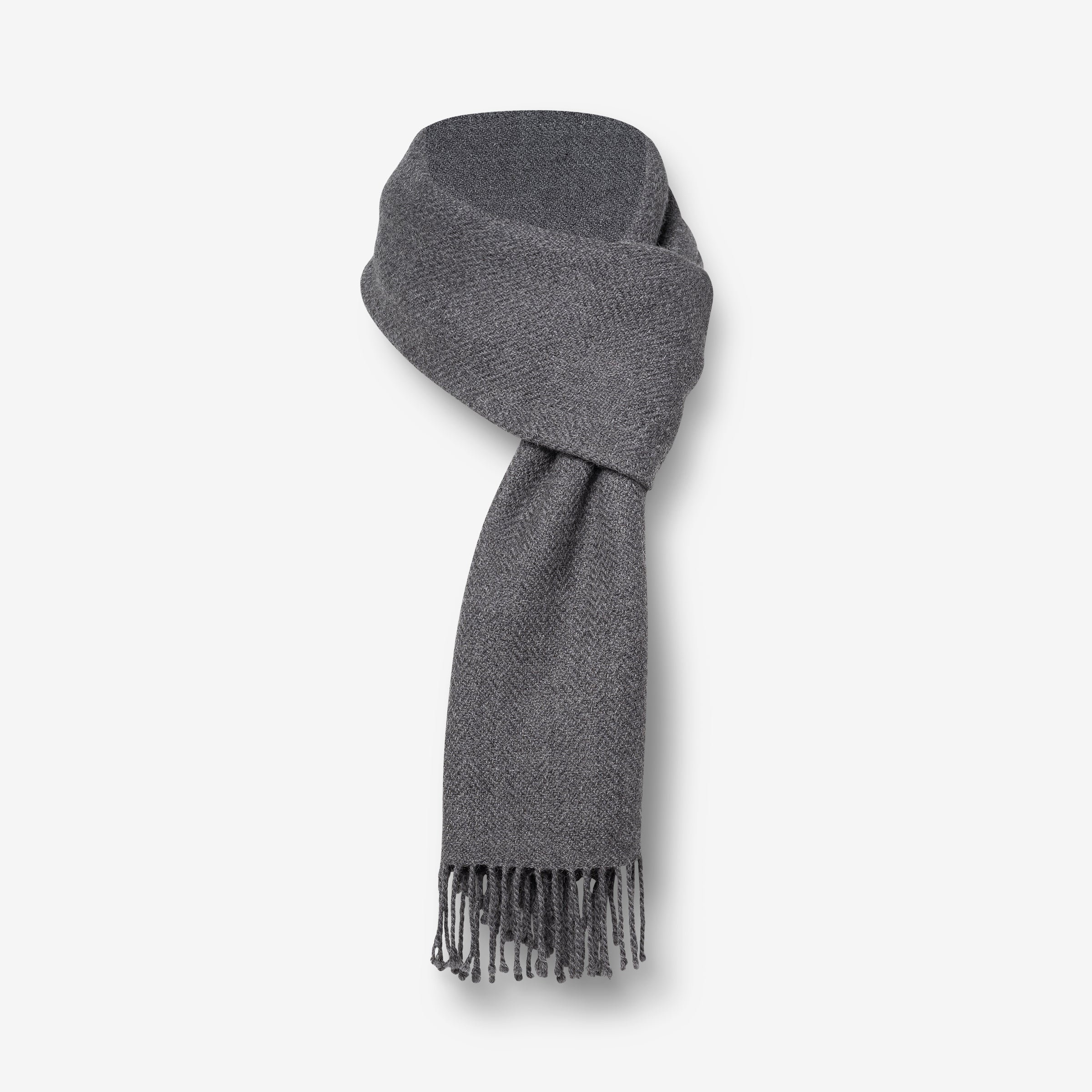 A handwoven alpaca stole in charcoal gray with fringes, displayed on a plain background.