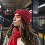 Girl wearing red scarf and red beanie in subway station